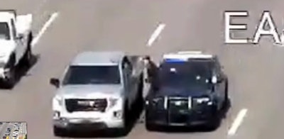 Screen grab from Macomb County Sheriff's Office video shows Deputy Nicole Miron climbing out of a moving patrol vehicle and into a truck driven by a man in medical crisis. No one was injured in the Sept. 12 incident.