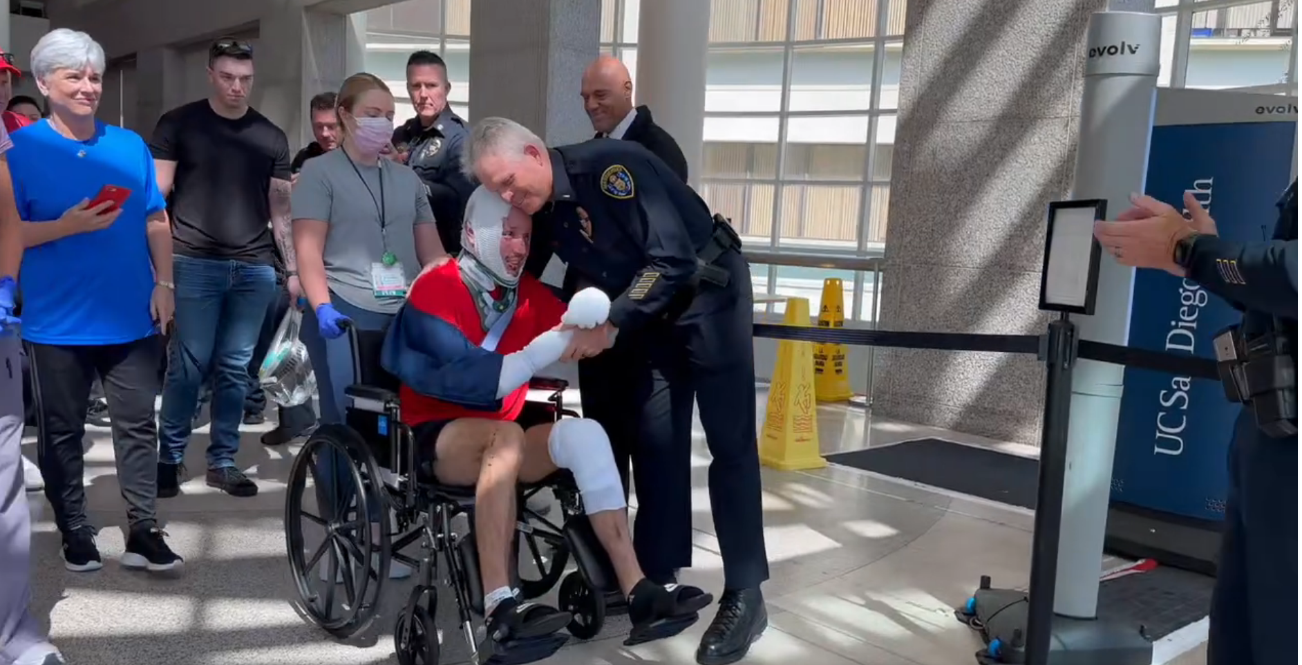 San Diego Police Officer Zachary Martinez is greeted by fellow officers as he goes home from the hospital. Martinez was severely injured and his partner was killed in a pursuit crash last week.