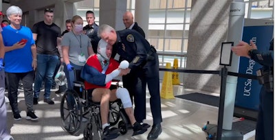 San Diego Police Officer Zachary Martinez is greeted by fellow officers as he goes home from the hospital. Martinez was severely injured and his partner was killed in a pursuit crash last week.