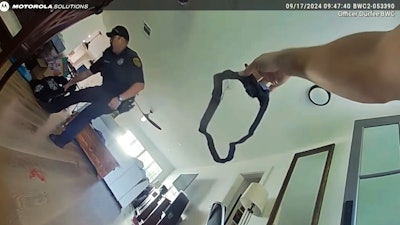 A wounded officer asks for help applying a tourniquet while the other officer detains a suspect following a shooting in Houston, Texas, earlier this week. Warning: The video may contain strong language.