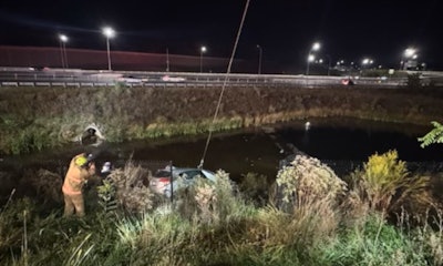 Two Virginia state troopers rescued a woman from her submerged car after it entered a retention pond with her inside. The car is shown being removed from the pond.