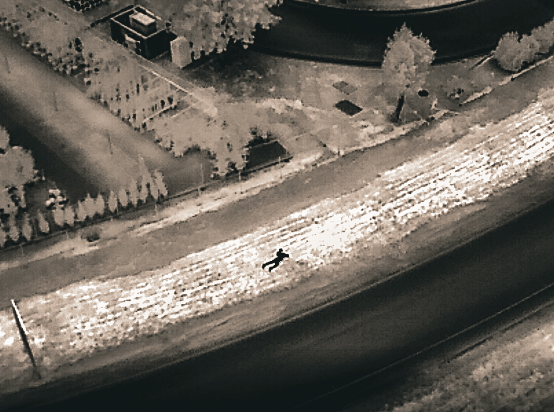 Image captured by an Elk Grove, California, Police drone shows a vehicle burglary suspect trying to hide from officers.