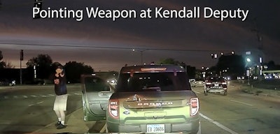 Screen shot from video jointly released by the Plano Police Department and Kendall County Sheriff's Office shows the suspect pointing shotgun at a deputy.