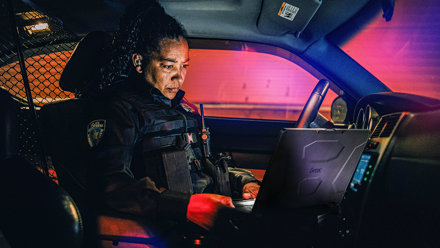Patrol officer using Getac rugged computer while on patrol.