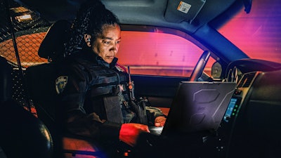 Patrol officer using Getac rugged computer while on patrol.