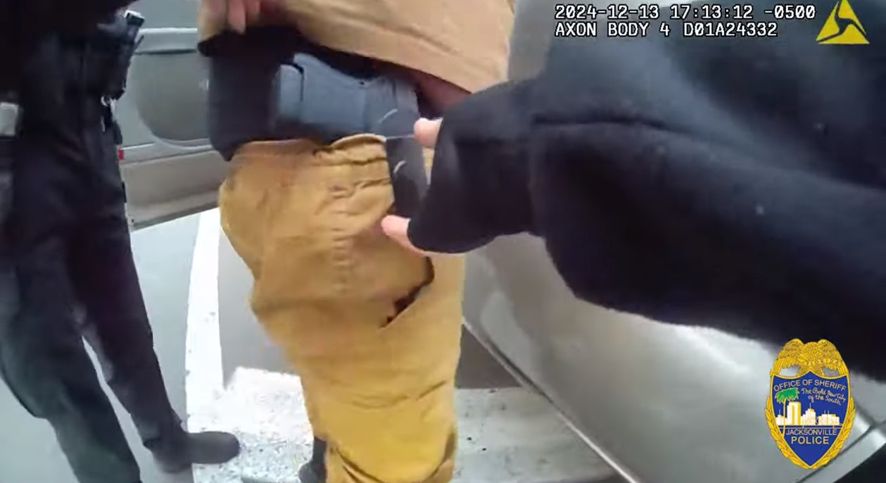 Jacksonville Police Officer Mindy Cardwell reaches for the pistol carried by Jason Arrington. Trying to take the pistol from the holster led to an accidental discharge that wounded Arrington.