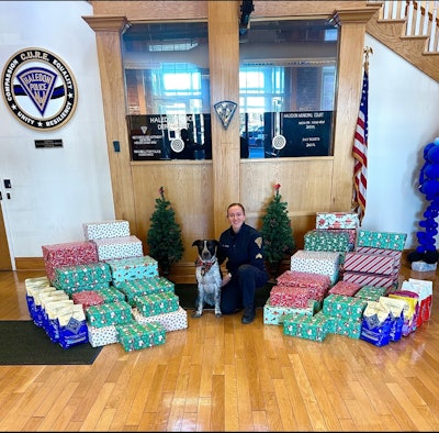 Nash and Cpl. April Latona with packages full of dog toys and treats for dogs in need.