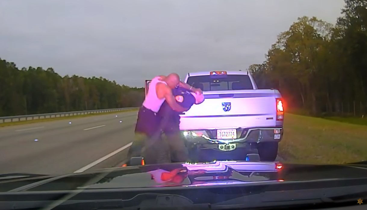 Screen shot from dashcam video showing Camden County sheriff’s Staff Sgt. Buck Aldridge assaulted by Leonard Allen Cure.