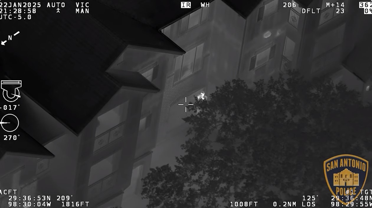Still from San Antonio Police video show suspect pointing gun at police helicopter.