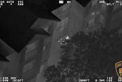 Still from San Antonio Police video show suspect pointing gun at police helicopter.