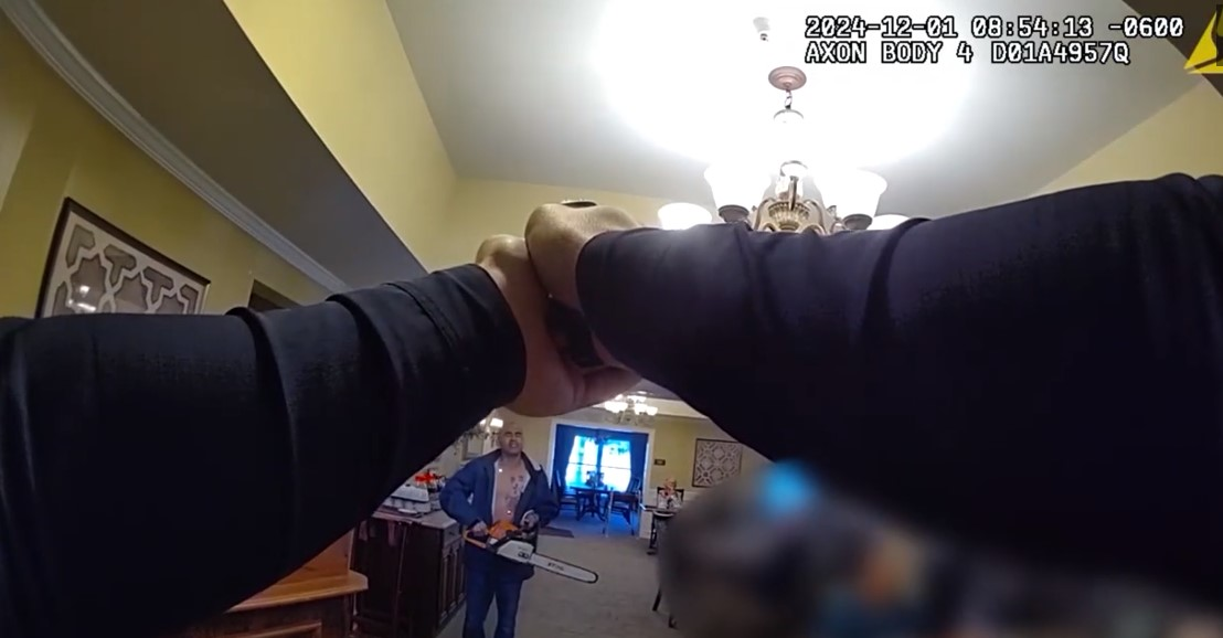 Still from body camera video shows St. Charles, Illinois, Police officer deploying his TASER on a chainsaw wielding suspect inside a senior home.
