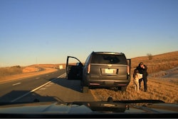 Kansas Highway Patrol trooper with 6-year-old kidnapping victim. The girl was discovered in an SUV with two 60-year-old men during a February traffic stop.