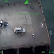 Still image from Orange County Sheriff's Department helicopter camera showing Santa Ana officers and suspect on Newport Beach Pier.