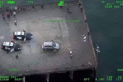 Still image from Orange County Sheriff's Department helicopter camera showing Santa Ana officers and suspect on Newport Beach Pier.
