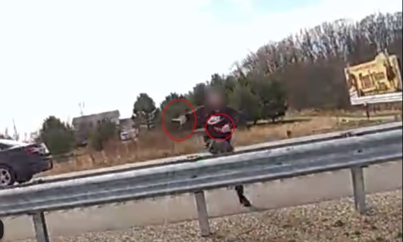 Man with two knives climbing a US127 guardrail to pursue Ingham County (Michigan) Sheriff's deputies on April 6, 2025. The man was fatally shot during the incident.