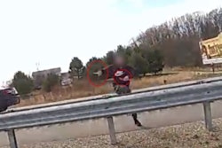 Man with two knives climbing a US127 guardrail to pursue Ingham County (Michigan) Sheriff's deputies on April 6, 2025. The man was fatally shot during the incident.