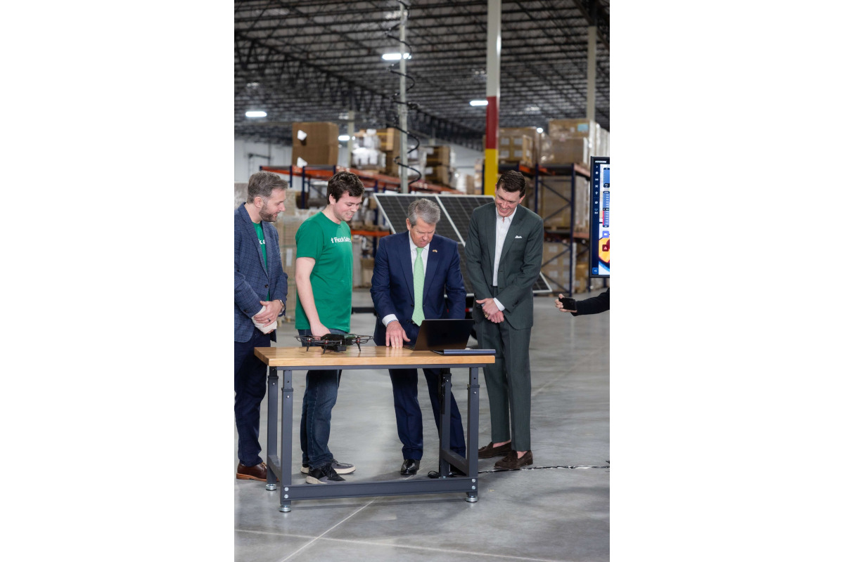 Georgia Governor Brian Kemp (blue suit) and Flock Safety CEO Garrett Langley inspect some of the company's new technology inside Flocks new Smyrna, Georgia, drone factory.
