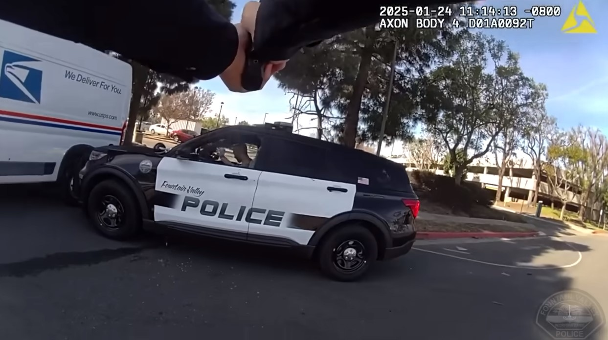 Body camera image showing officer aiming at suspect in patrol vehicle during January fatal shooting in Fountain Valley, California.