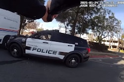Body camera image showing officer aiming at suspect in patrol vehicle during January fatal shooting in Fountain Valley, California.