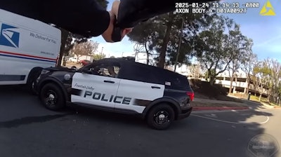 Body camera image showing officer aiming at suspect in patrol vehicle during January fatal shooting in Fountain Valley, California.