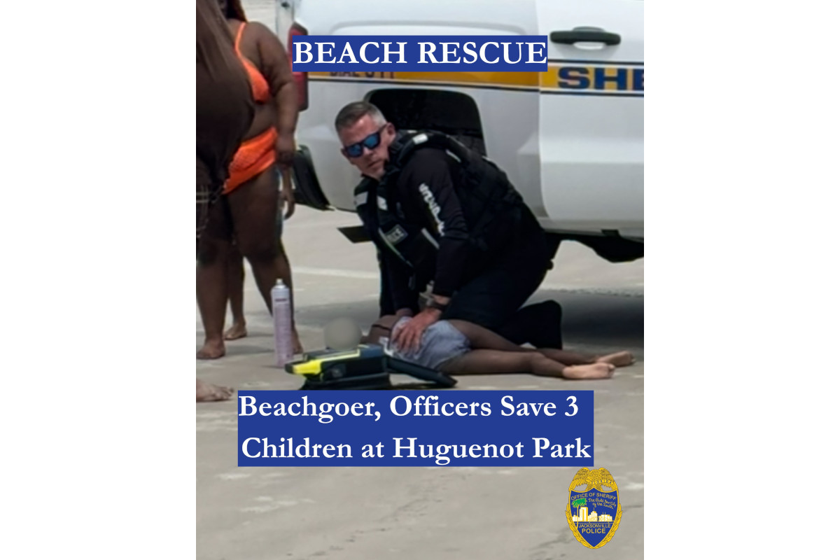 Officer Billy Crocker of the Jacksonville Sheriff's Office works to resuscitate a child who was drowning at a local beach Saturday.