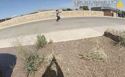 Still from El Paso Police video shows suspect with gun and officer firing back.