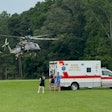 A Maryland State Police helicopter deliver a victim from a boating accident to a waiting ambulance.