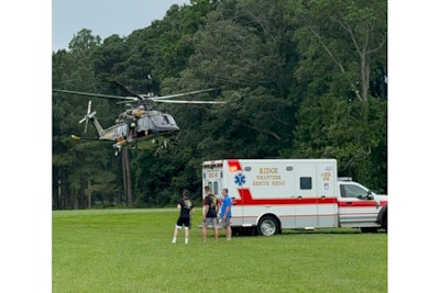 A Maryland State Police helicopter deliver a victim from a boating accident to a waiting ambulance.