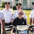 Kidney failure patient Wyatt atop a Suffolk County Sheriff's Office motorcycle and surrounded by Sheriff Errol Toulon Jr. and deputies.
