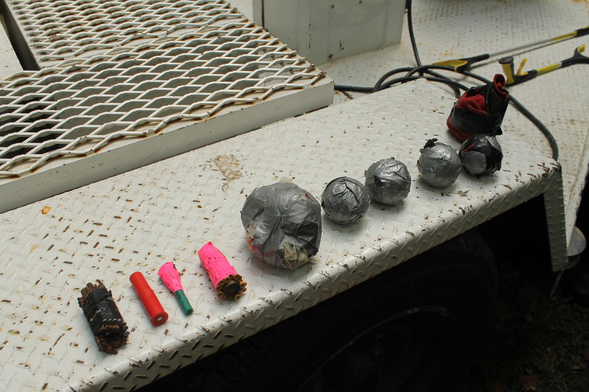 Officers and deputies found these suspected IEDs inside the home of a man wanted for threatening police and public officials.