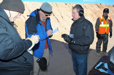 Me in the black hoodie interviewing an industry rep about a pistol I just shot...badly on a SHOT Show range.